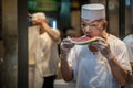 Chinese chef eating watermelon