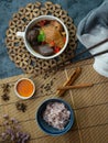 Chinese chicken soup in a white cup, decorated with Chinese shiitake mushrooms, goji berries, chicken blood and coriander leaves. Royalty Free Stock Photo