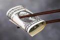 Chinese chopsticks hold one dollar. A concept on the relationship between America and China