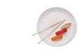 Chinese chopsticks with sushi in the corner with plate for text