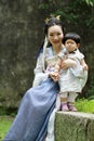 Chinese classic woman in Hanfu dress enjoy free time with baby and close friends Royalty Free Stock Photo