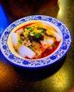 Chinese Cold Mung Bean Noodles Topped with Black Bean Chili Sauce, Roast Peanuts and Green Spring Onions.