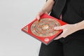 Chinese compass Lopan for Feng Shui technique in female hands is