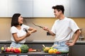 Chinese Couple Having Fun In Kitchen Fencing With Cooking Tools Royalty Free Stock Photo