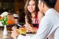 Chinese couple having romantic dinner in fancy restaurant