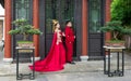 Chinese couple with traditional red costumes posing for wedding pictures at Qingchuan Pavilion in Wuhan China