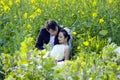 Chinese couple wedding portraint in cole flower field Royalty Free Stock Photo