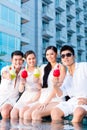 Chinese couples drinking cocktails in hotel pool bar Royalty Free Stock Photo