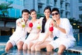 Chinese couples drinking cocktails in hotel pool bar Royalty Free Stock Photo