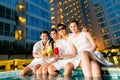 Chinese couples drinking cocktails in hotel pool bar Royalty Free Stock Photo