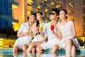 Chinese couples drinking cocktails in hotel pool bar Royalty Free Stock Photo