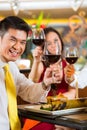 Chinese couples toasting with wine in restaurant Royalty Free Stock Photo