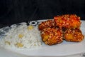 Chinese crispy sesame chicken with rice and corn