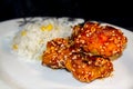 Chinese crispy sesame chicken with rice and corn