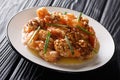 Chinese crispy shrimp tossed in a creamy, sweet sauce topped with caramelized walnuts close-up. horizontal Royalty Free Stock Photo