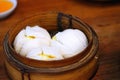 Chinese cuisine, hot and steamy dim sim or steamed Chinese dumplings were set in steamer basket. Steamed Buns Royalty Free Stock Photo