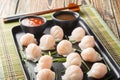 Chinese dim sum Har Gow dumplings with shrimp served with sauce closeup. Horizontal