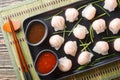 Chinese dim sum Har Gow dumplings with shrimp served with sauce closeup. Horizontal top view