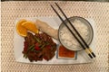 Chinese dinner served with rice, beef and spring rolls