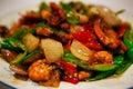 Chinese dish fried vegetables with shrimps in a sweet sauce, served on a white plate. Beijing, China.