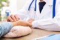 A Chinese doctor in a white lab coat is checking the pulse of a patient Royalty Free Stock Photo