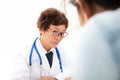 A Chinese doctor in a white lab coat is checking the pulse of a patient Royalty Free Stock Photo