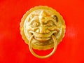 Chinese door knocker on red door background Royalty Free Stock Photo