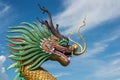 Chinese Dragon statue under blue sky.