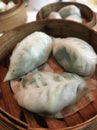 Authentic Chinese dumplings or Dim Sum on a wooden basket, Asian delight