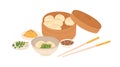 Chinese dumplings served in traditional box with sesame sauce bowl and chopsticks. Asian dough food with green filling