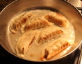 Chinese Dumplings Sizzle in a Frying Pan, Closeup