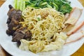 Chinese egg noodles topping slice barbecue pork and braised rib with dumping dressing sweet black sauce on plate Royalty Free Stock Photo