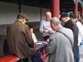 Chinese Elderly plays card game at the Temple of Heaven. Travel