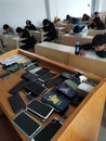 Chinese English students having an exam at college and their mobile phones.