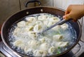 Chinese Family Cook Boilded Dumplings in a Wok Royalty Free Stock Photo