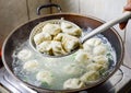 Chinese Family Cooking Boiled Dumplings in Wok Royalty Free Stock Photo