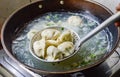 Chinese Family Cooking Boiled Dumplings in Wok Royalty Free Stock Photo