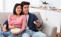 Chinese Family Couple Watching TV Together In Living Room Royalty Free Stock Photo