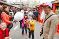 Chinese family has fun with cotton candy. Father with emperor beard made of cotton candy
