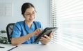 Chinese Female Doctor holding digital tablet Royalty Free Stock Photo