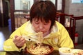 Chinese female eating noodles