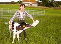 Chinese female farmer taking care of newborn calf in livestock farm