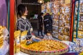 Chinese female snack seller waits for her customer at her snack