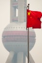 Chinese flag, and pollution haze on Oriental Pearl Tower, Shanghai