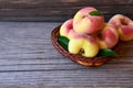 Chinese flat donut peaches in the basket on on old wooden table also known as Saturn donut, Doughnut peach, Paraguayo.Healthy eati Royalty Free Stock Photo