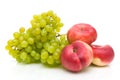 Chinese flat peaches and green grapes on white Royalty Free Stock Photo
