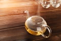Chinese flower bound tea in a transparent teapot with condensation and steam. Concept of tea ceremony with the disclosure of tea i
