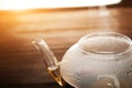 Chinese flower bound tea in a transparent teapot with condensation and steam. Concept of tea ceremony with the disclosure of tea i