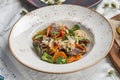 Chinese food beef noodles with broccoli, carrot, pepper and sesame seeds on the table Royalty Free Stock Photo