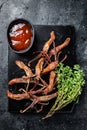 Chinese food dip fried duck tongue Black background. Top view Royalty Free Stock Photo